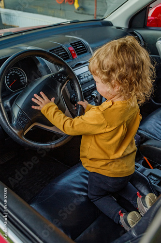 Child playing with vehicle horn photo