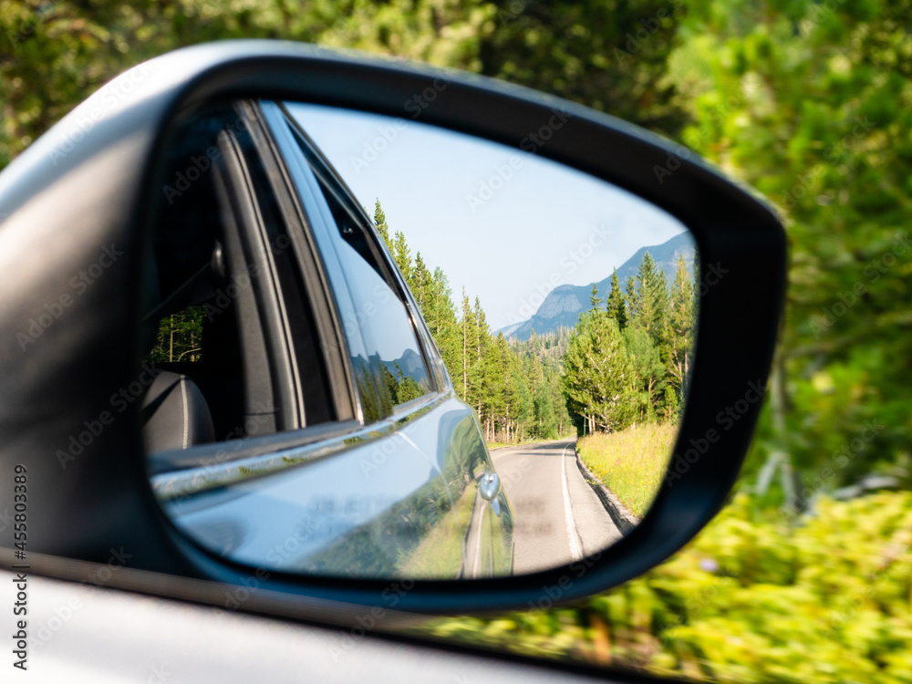 Rear view mirror view while driving through the Rocky Mountains of Colorado.