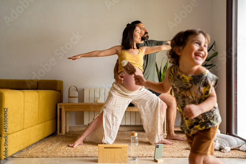 Couple practicing yoga together at home photo