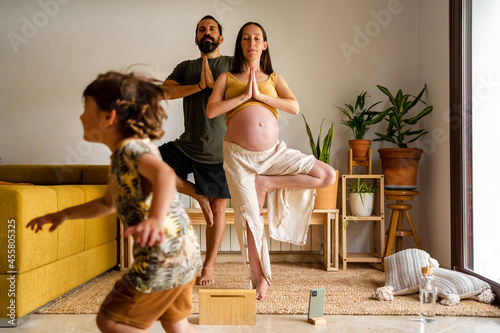 Couple doing yoga postures at home photo