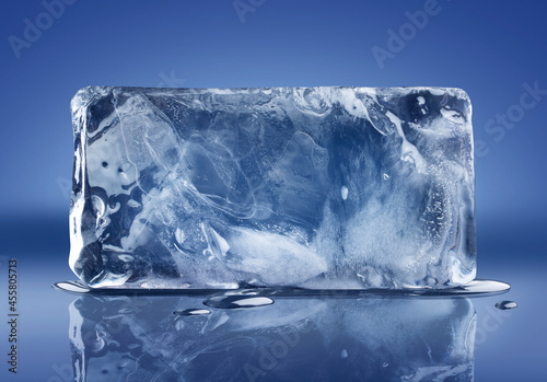 A horizontal rectangular block of ice on blue background with clipping path.