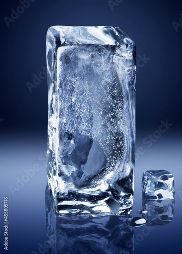 Vertical rectangular block of ice on dark blue background.