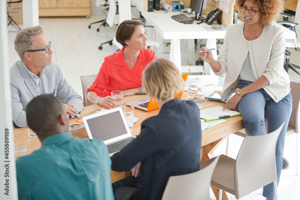 Office workers having meeting at desk Office workers having meeting at desk