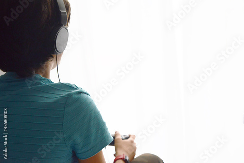 Boy playing game console with a headset play station