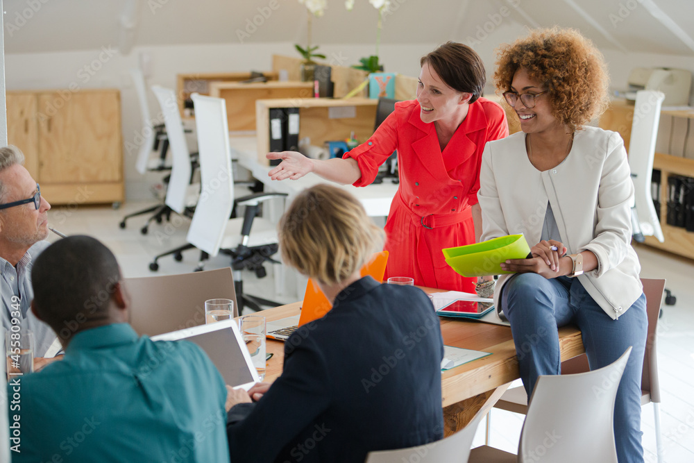 Office workers having meeting at desk Office workers having meeting at desk