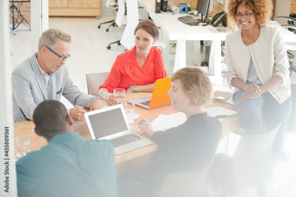 Office workers having meeting at desk Office workers having meeting at desk