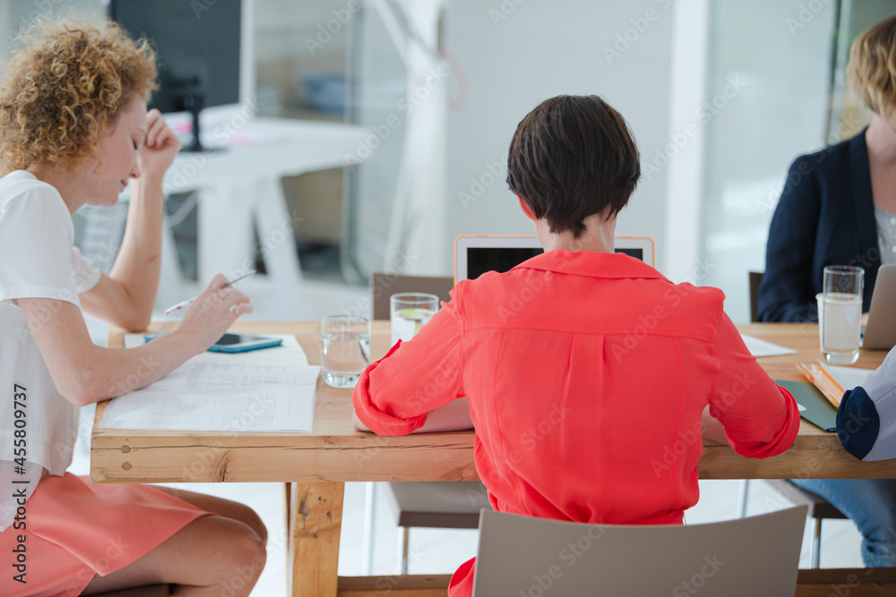 Office workers having meeting at desk Office workers having meeting at desk
