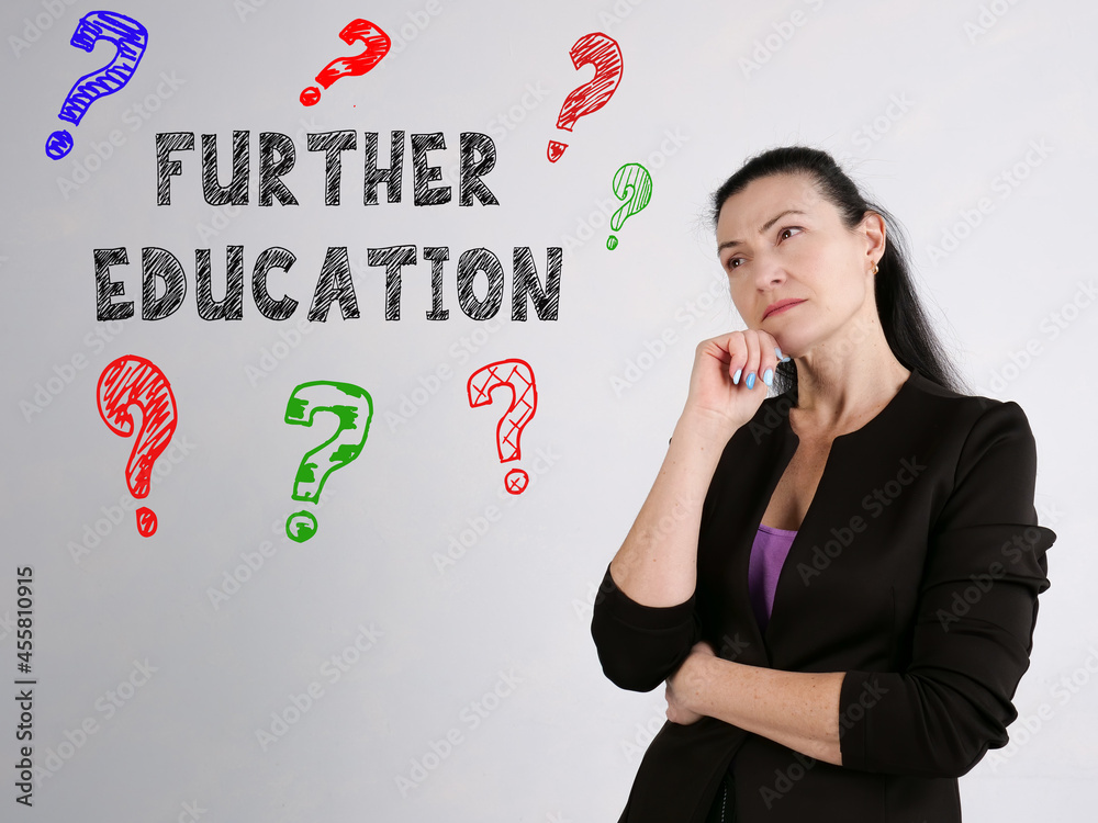 Financial concept meaning FURTHER EDUCATION question marks with inscription on the wall Financial concept meaning FURTHER EDUCATION question marks with inscription on the wall