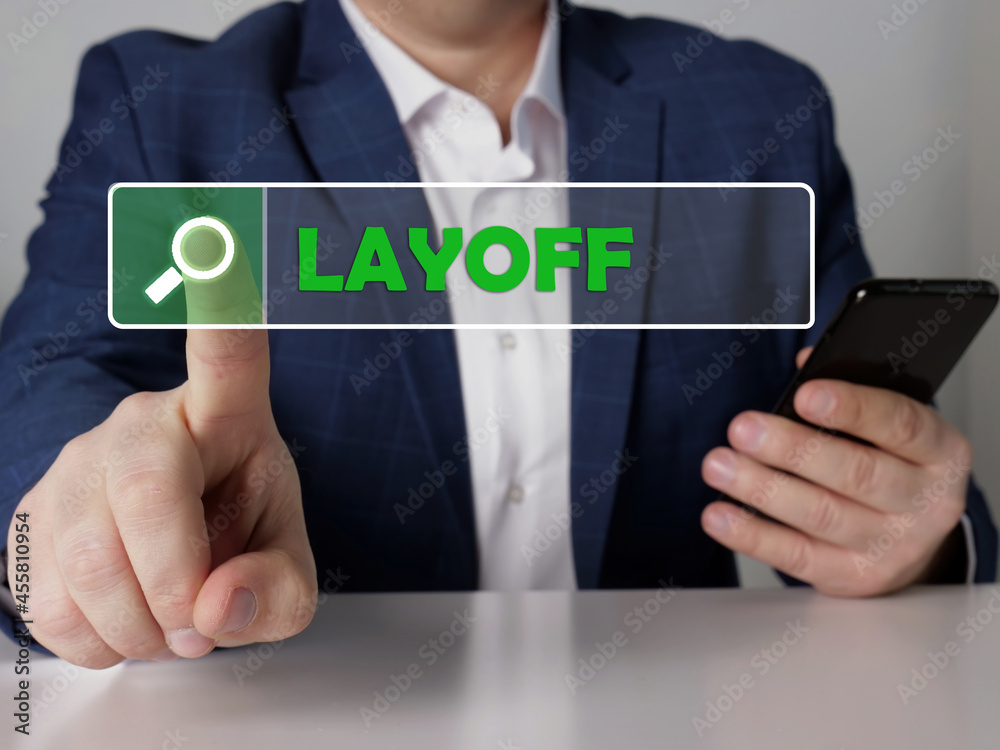 LAYOFF phrase on the screen. Bookkeeping clerk use cell technologies at office. Concept search and LAYOFF . LAYOFF phrase on the screen. Bookkeeping clerk use cell technologies at office. Concept search and LAYOFF .