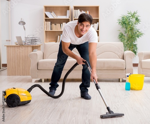 Man cleaning home with vacuum cleaner