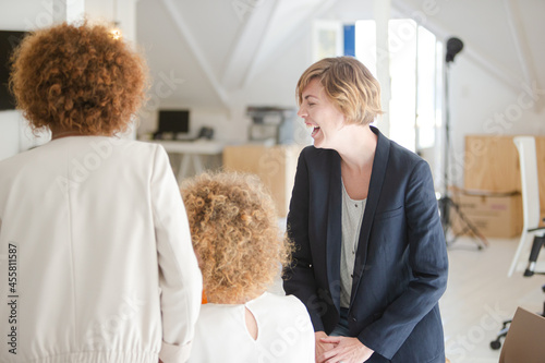 Office workers talking at desk