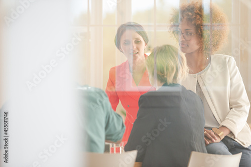 Office workers talking at meeting