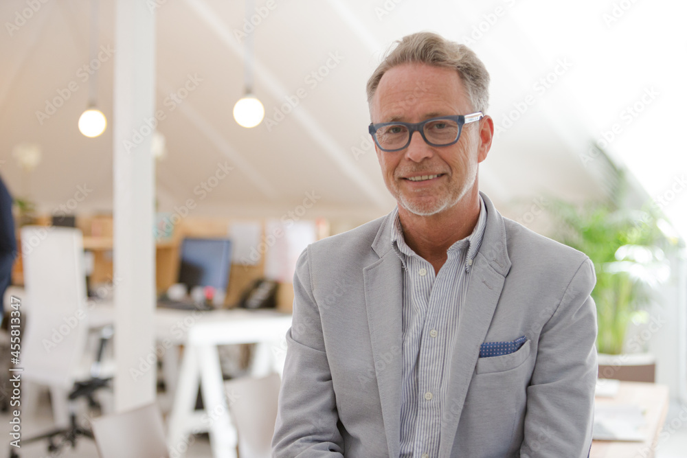 Portrait of businessman smiling in office