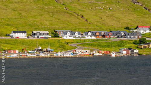 Beautiful aerial view of the town of Miovagur in the Faroe Islands, with its :churchs, grass roofs and colorful Houses in front of the ocean 