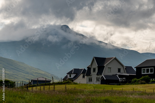 Beautiful aerial view of the town of Miovagur in the Faroe Islands, with its :churchs, grass roofs and colorful Houses in front of the ocean 