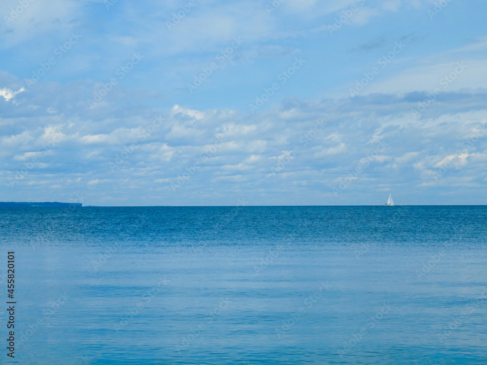 Summer by the beach of lake and sailboat.