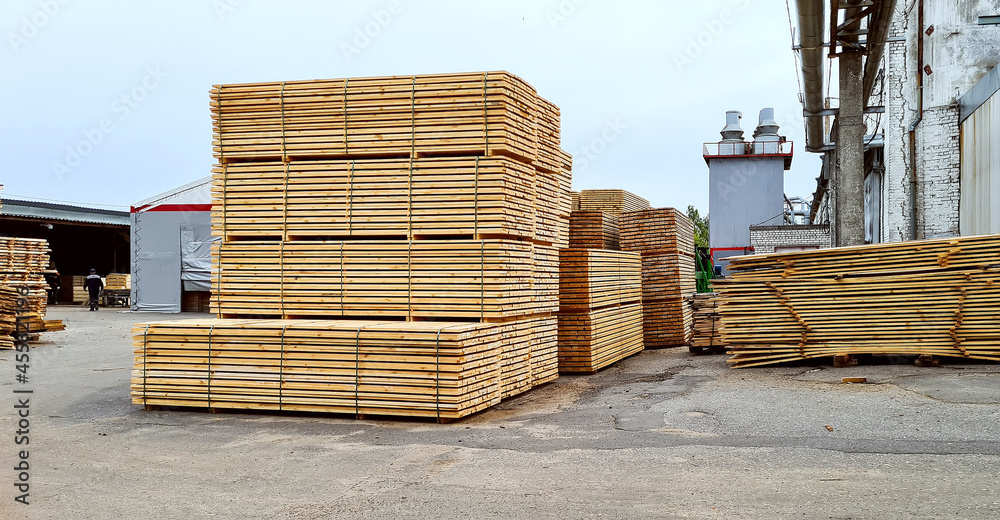 Packed boards, lumber piles in the finished goods warehouse Packed boards, lumber piles in the finished goods warehouse