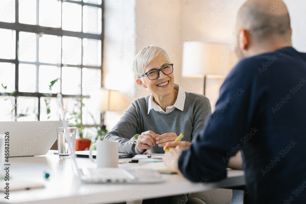 © Mihajlo Ckovric/Stocksy - Businesspeople having a meeting in the office