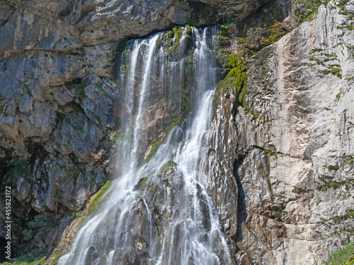 Waterfall on gray stone rock texture background