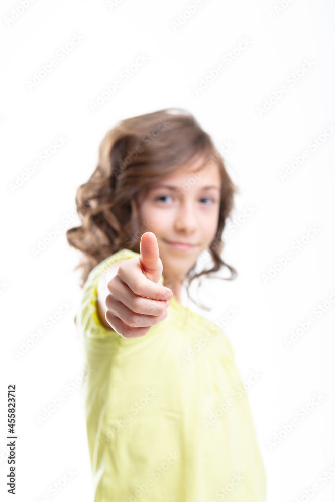 Cute little girl giving a thumbs up gesture with a smile Cute little girl giving a thumbs up gesture with a smile