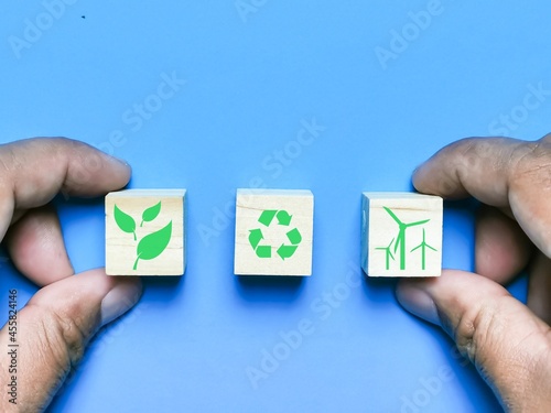 Technology and business ecology concept with environment icons on wooden cubes.