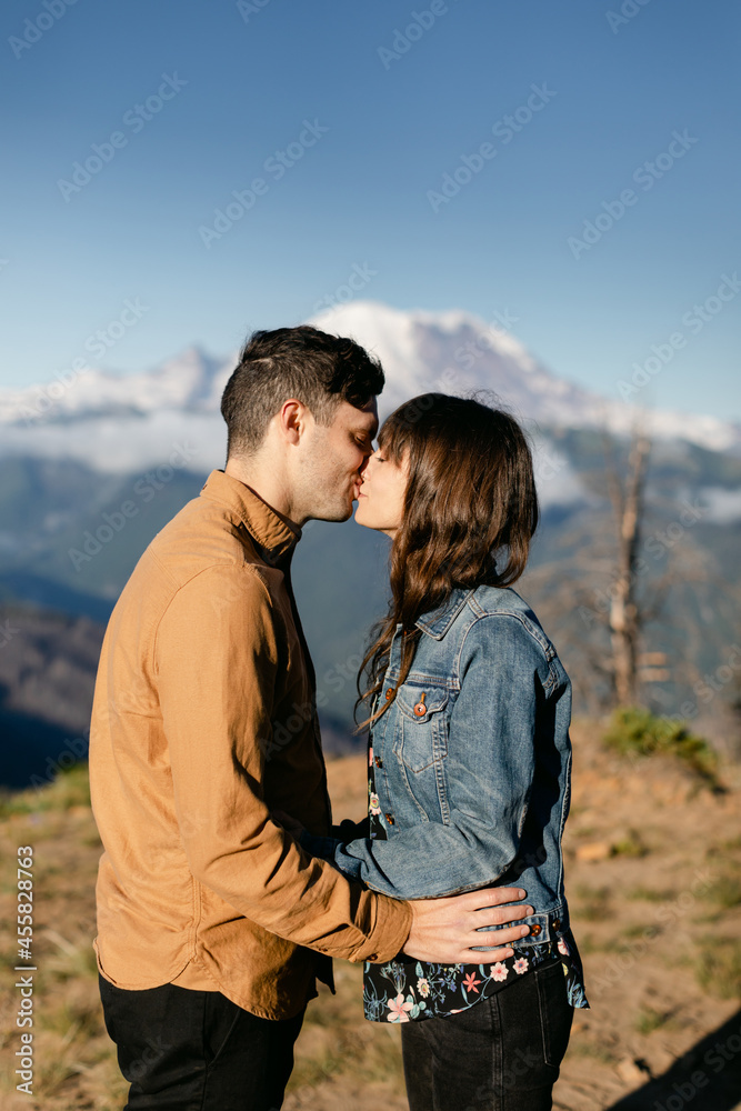 A Couple Kiss in front of a Mountain A Couple Kiss in front of a Mountain
