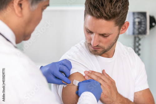 Exam: Doctor Applies Bandage to Arm