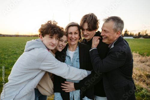 Fun loving family hugging together outside. photo
