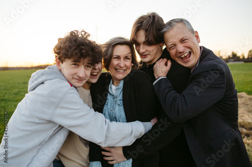 Fun loving family hugging together outside. photo