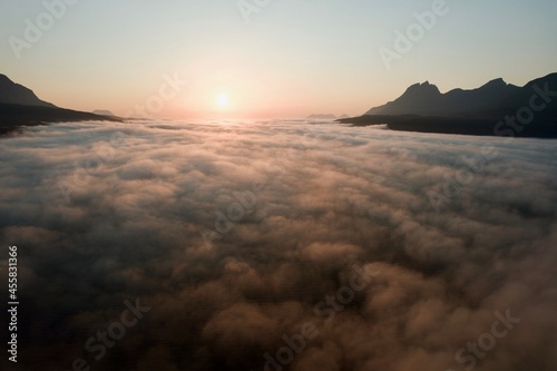 Flying, dreaming above golden cloudscape, aerial