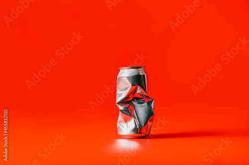 A Crushed can with red background photo
