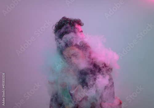 Couple hug inside a smoke cloud photo