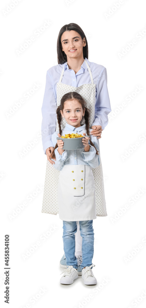 Young mother and daughter with tasty dish in saucepot on white background Young mother and daughter with tasty dish in saucepot on white background