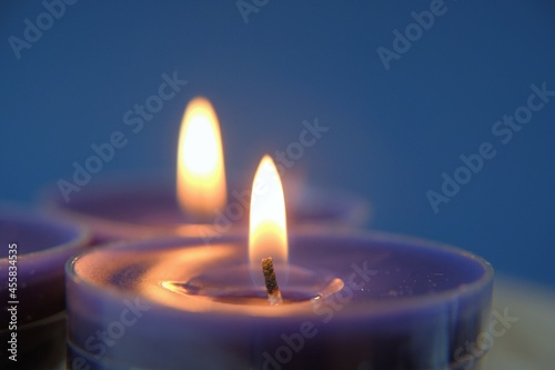 Candle flame.Set of blue candles in the dark.Religion symbol. Candles background.Blue candles on dark blue background. 