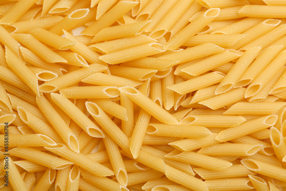 Uncooked penne pasta as background Uncooked penne pasta as background