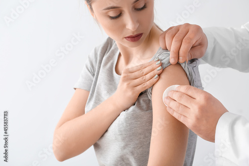 Doctor applying cotton pad ...