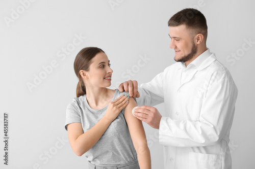 Doctor applying cotton pad ...