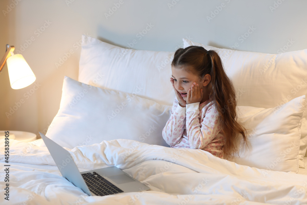 Surprised girl watching cartoons in bedroom Surprised girl watching cartoons in bedroom