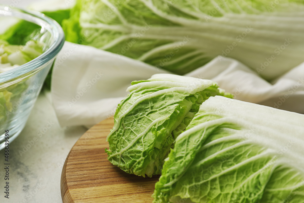Board with fresh chinese cabbage on light background, closeup Board with fresh chinese cabbage on light background, closeup