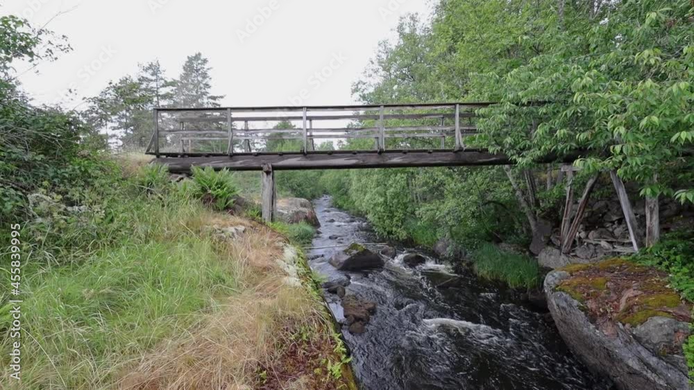 Wooden bridge over stream Emån, summertime Sweden Wooden bridge over stream Emån, summertime Sweden