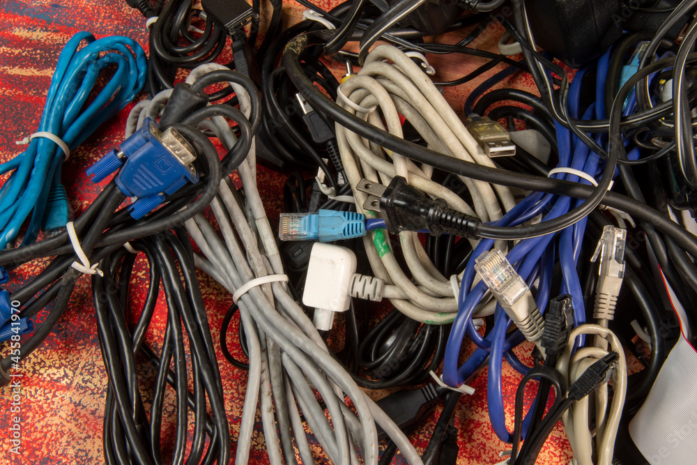 Disused stack of old computer cables and devices.. Stock Photo Adobe