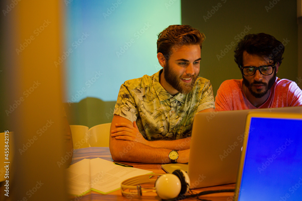 Casual businessman preparing audio visual presentation in office Casual businessman preparing audio visual presentation in office