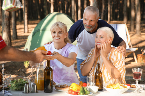 Mature people at barbecue p...