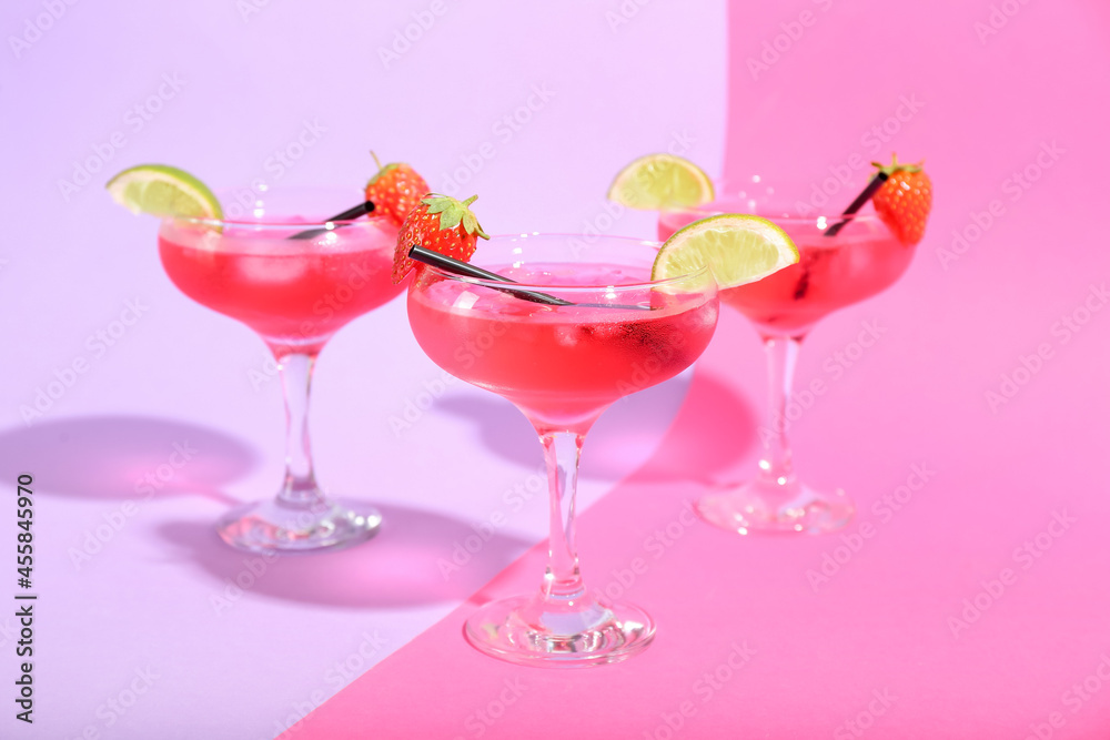 Glasses of tasty cosmopolitan cocktail on color background Glasses of tasty cosmopolitan cocktail on color background