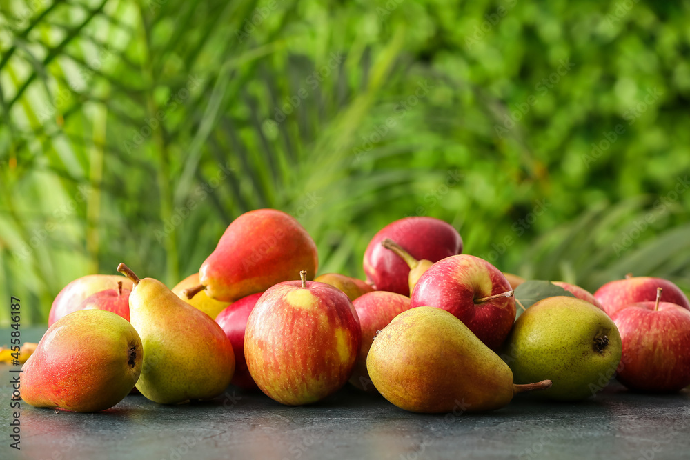 Ripe pears and apples on table outdoors Ripe pears and apples on table outdoors