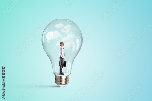 Business man standing inside a light bulb