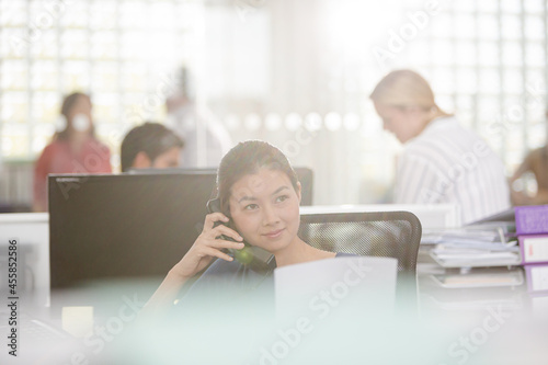 Smiling businesswoman talking on cell phone