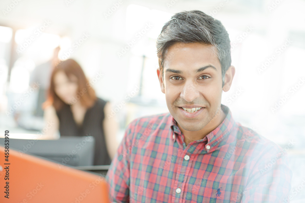 Portrait of smiling fashion designer in office Portrait of smiling fashion designer in office