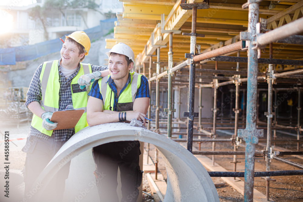 Portrait confident engineers with clipboard at construction site