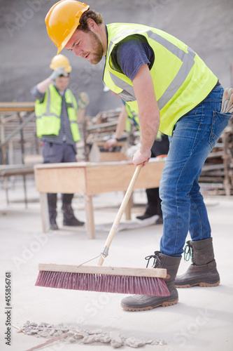 Construction worker sweeping at construction site